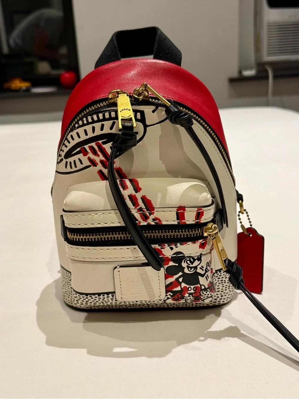 Coach & Disney mini backpack Red & Cream Keith hearing special edition.